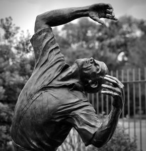 Black-and-white study of a bronze dancer sculpture