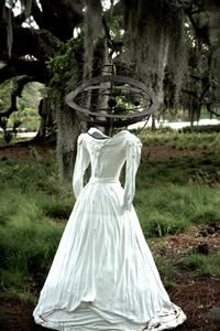 White dress sculpture in trees