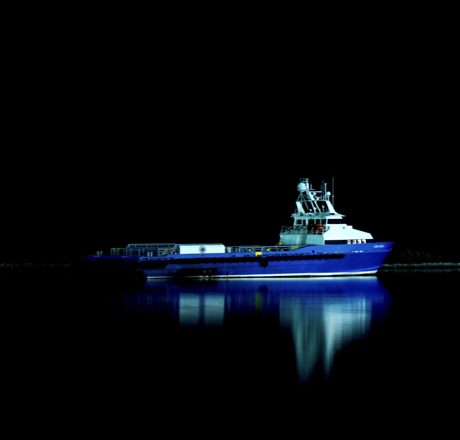 Blue workboat on black water